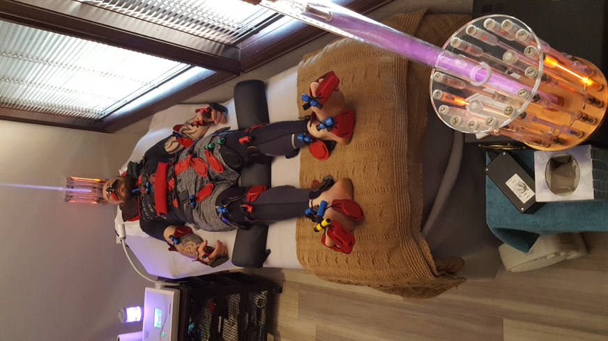 American Ninja Warrior contestant lying on a table using NanoVi, biomagnets, and energy lights