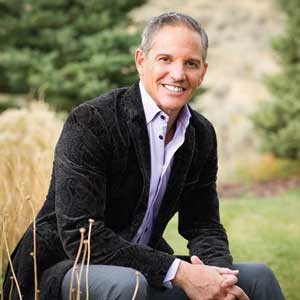 Dr Dan Pompa poses in a field