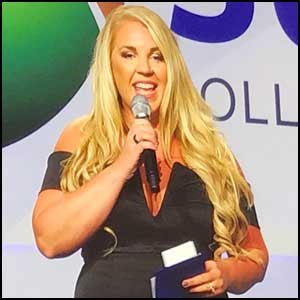 Katie Wells speaks on stage at Mindshare