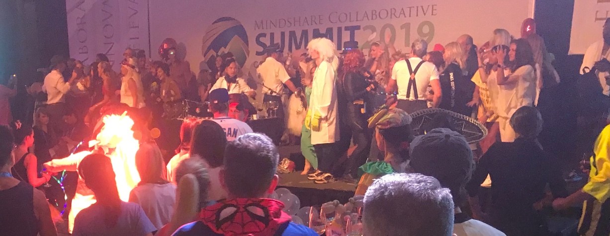 Costumed Mindshare attendees party on and around the mainstage