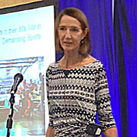 Rowena Gates speaking onstage at the RAADfest life extension conference